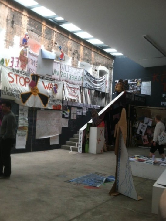 Inside entrance to the KW Institute Contemporary Art during the 7th Berlin Biennale and installation shot of “Global Square” encampment. Image courtesy of the author.