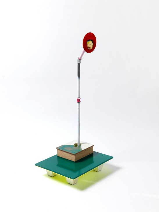 Steve Locke, “in the watching,” 2013, egg tempera and oil on wood, attached to wood base with collage, milk paint, and enamel, beveled and painted on bottom with painted wood legs. With stripped and painted poles, connectors, and flanges. Image by Stewart Clements. Courtesy of the artist and SAMSON, Boston